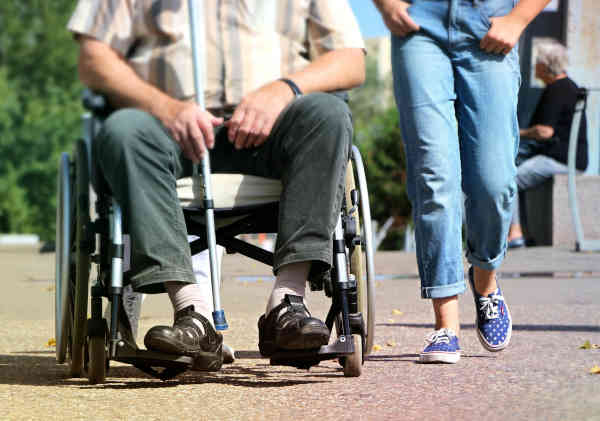 Wheelchair user enjoying plants and flowers